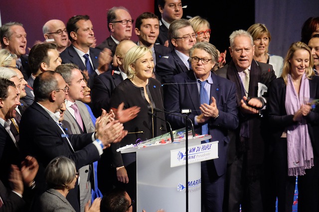 People surrounding woman giving speech